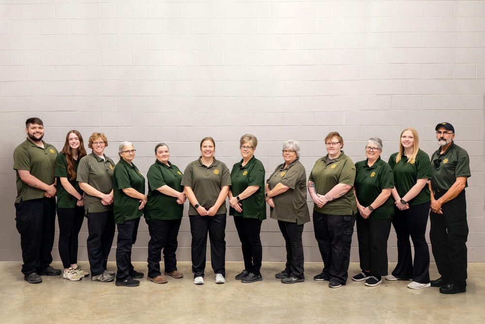 Group of Dispatchers and Jailers standing next to each other and smiling.