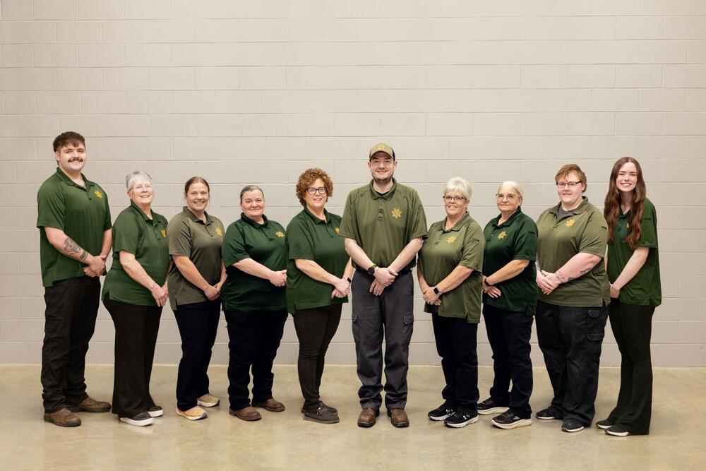 Group of Dispatchers and Jailers standing next to each other and smiling
