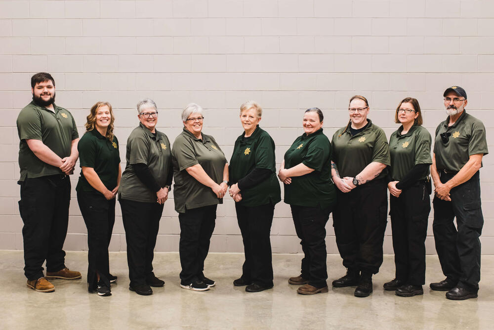 Group of Dispatchers and Jailers standing next to each other and smiling.